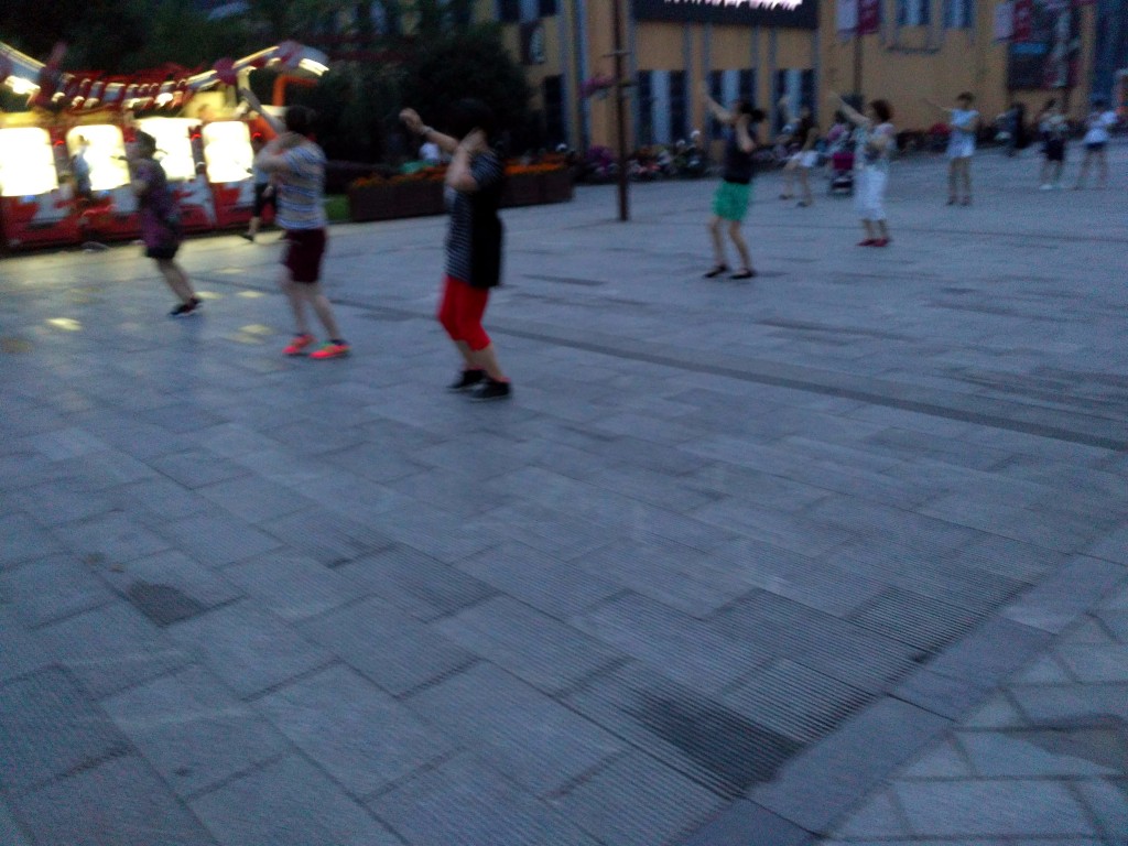 Middle-aged plaza dancer community group dancing to 小苹果.