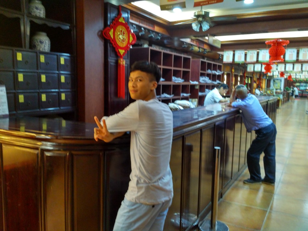 Their cousin Vincent (who's fluent in English) is getting a prescription of Chinese traditional medicine at the historic pharmacy.  You should have seen his face after he took it! XD