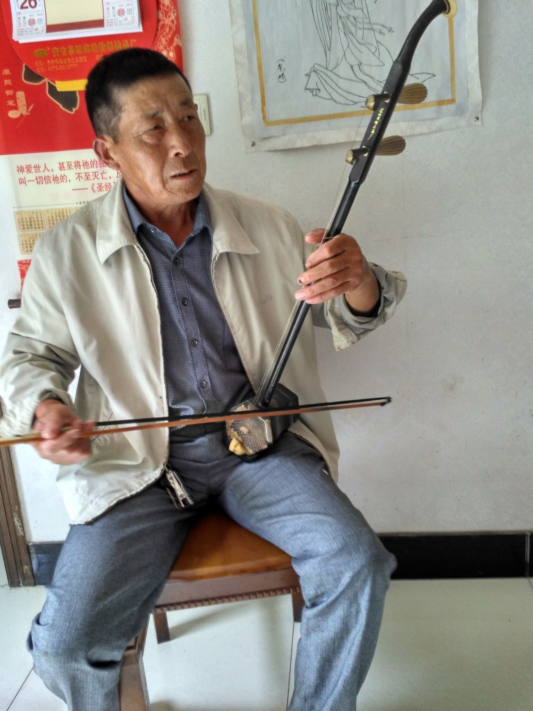 Grandpa playing the Erhu, a traditional Chinese instrument with a beautiful and unique sound.
