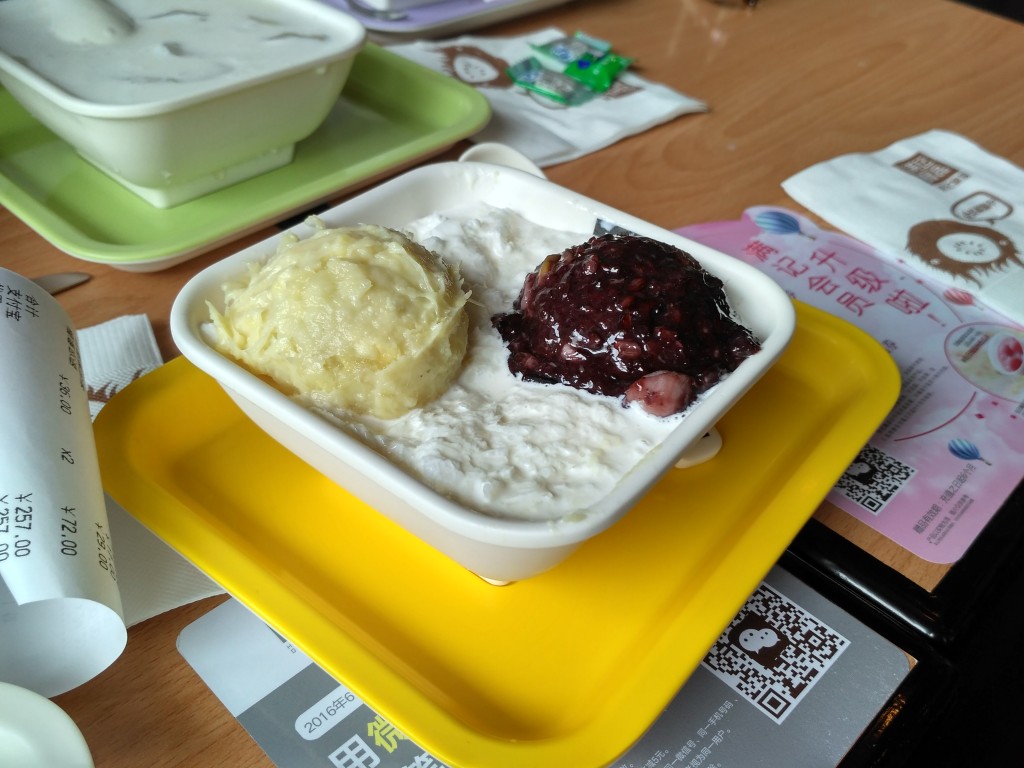 Sweet coconut ice milk with scoops of (not ice cream) Durian and Black Bean (maybe?) paste.  Definitely a strong non-Western flavor, but pretty good after a few bites.