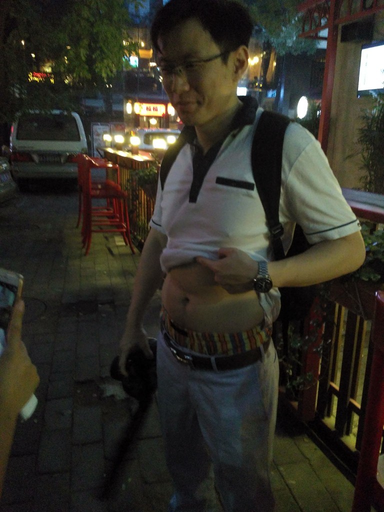 A Beijing Bikini refers to the way Chinese men roll up their shirts when it's hot. The evening wasn't nearly warm enough for a natural spotting, so we made our team member do it.